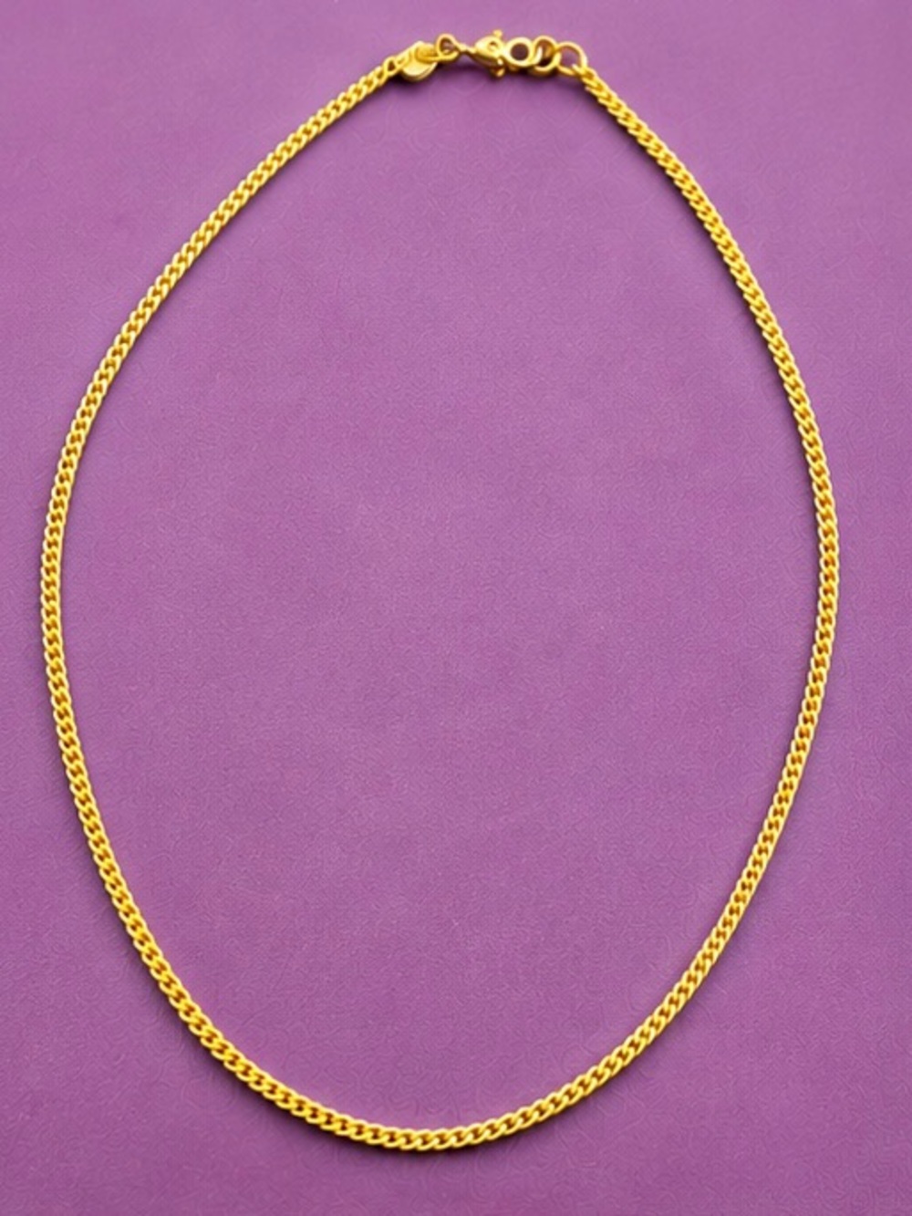 Monet Gold-Tone Curb Chain Necklace on Purple.